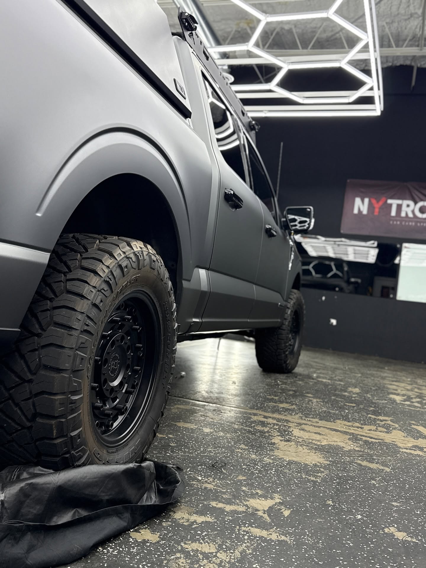 Matte grey lifted truck detailed in the Auto Luxe shop